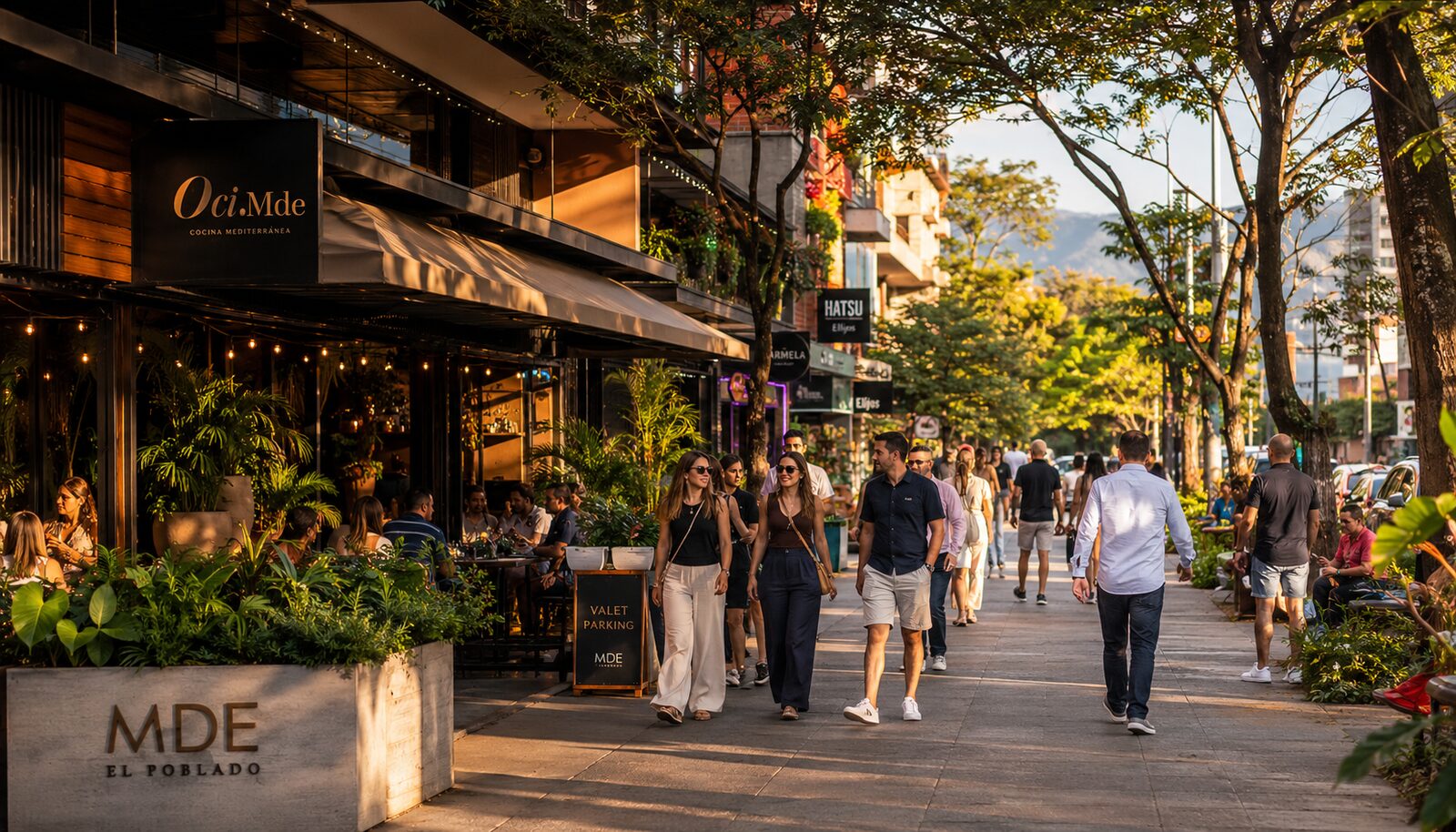 Vibrant tree-lined street in El Poblado Medellín with restaurants and pedestrians